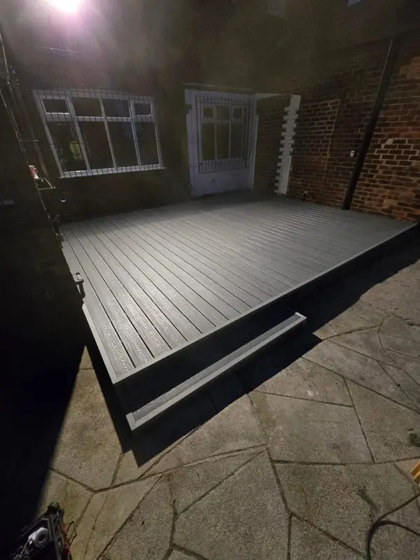 Grey composite deck built over the same side yard